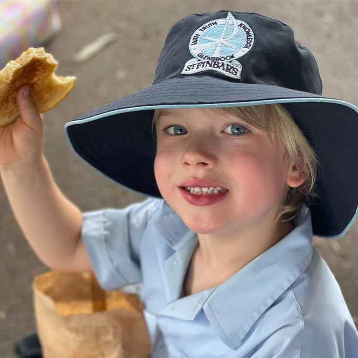 Student smiling with a pancake at St Finbar’s Catholic Primary Glenbrook